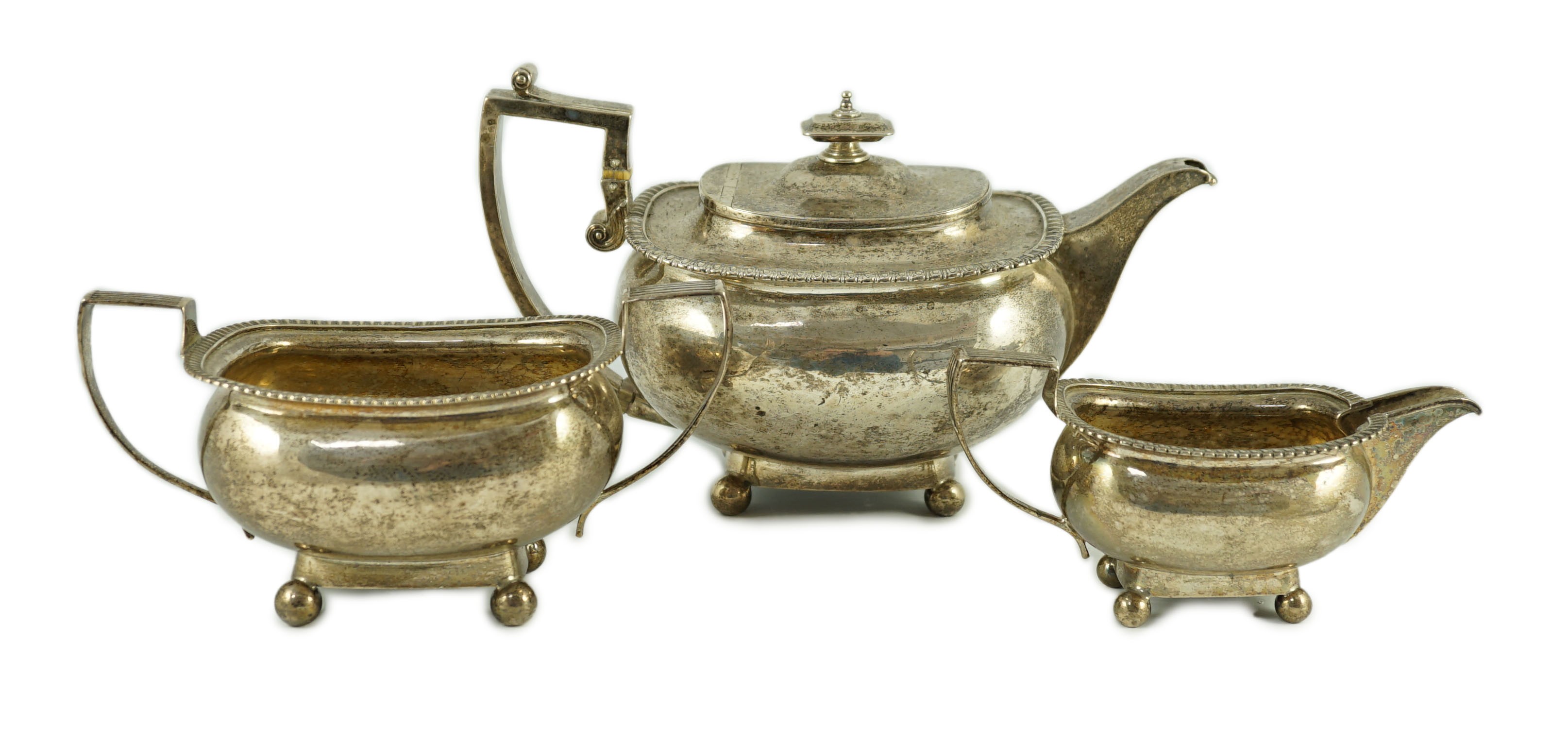 A George III silver three piece 'London' shape tea service, by Samuel Hennell